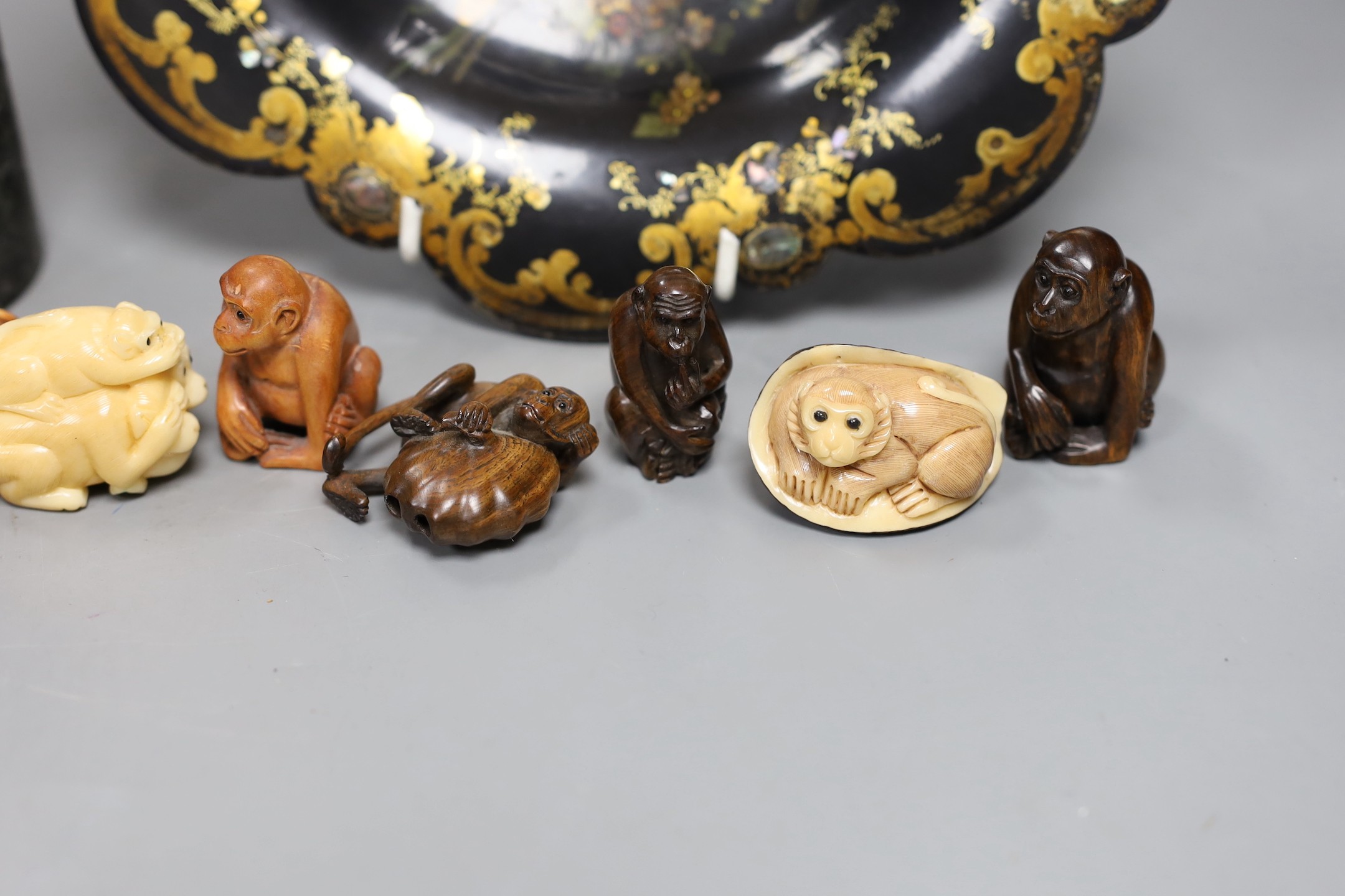A Chinese soapstone brush pot and a group of netsuke and a papier mache dish, 26cms diameter